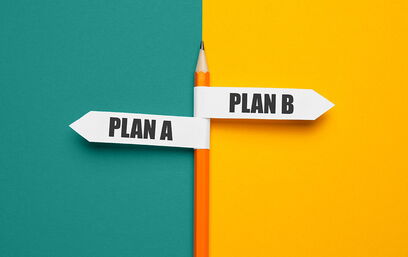 Pencil with signs Plan A and Plan B on a split turquoise and yellow background