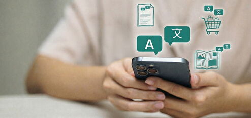 A translation icon hovers above a smartphone. Above it are further icons for documents, shopping carts, and magazines.