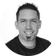 Portrait of a man in a black shirt in front of a white background