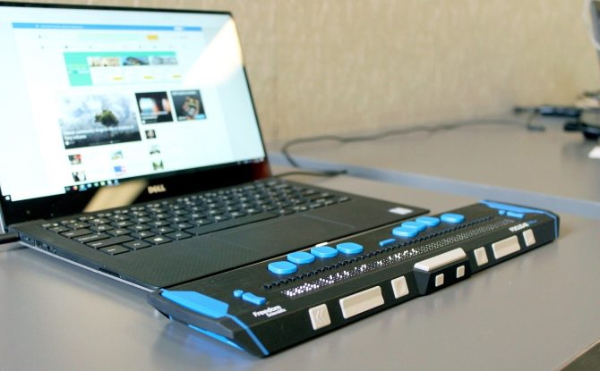 Keyboard for blind people in front of a laptop