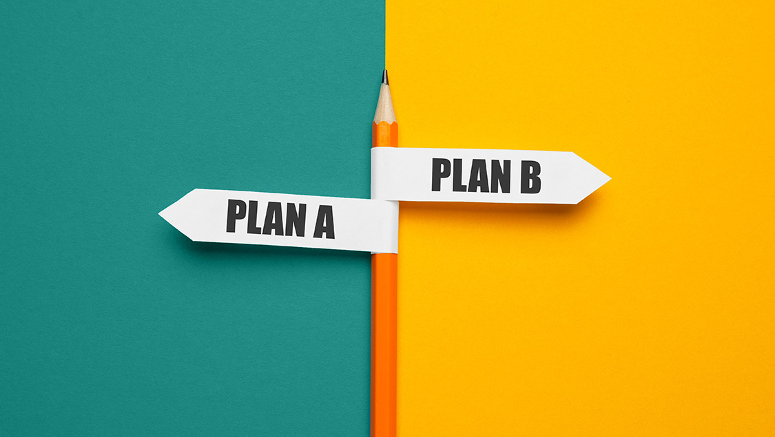 Pencil with signs Plan A and Plan B on a split turquoise and yellow background